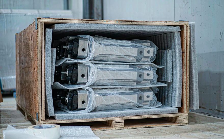 Precision CNC machined parts packed in a foam-lined wooden export crate